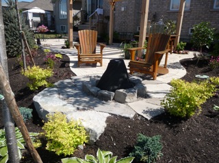 This brick patio extends out to a cozy little firepit area.