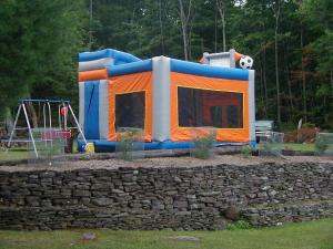 A children's play area is surrounded by this stone wall. 
