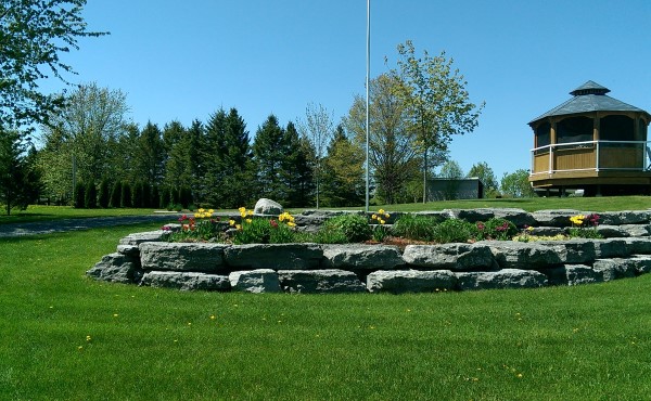 This large block limestone wall makes for a great raised garden bed to welcome visitors to this large property.