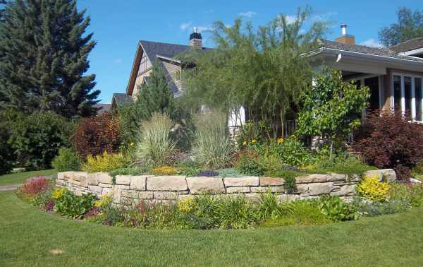Corner lot landscaping ideas like this small curved stone are a great way to add curb appeal.