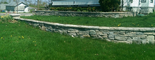 A local landscaper I met built this wall for his own house using left over mixed pieces from many different projects. Mixed walls seem to have the most character.