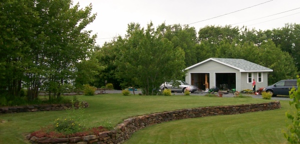 Add interest to a front yard by creating multiple levels with a stone wall. This dry-stacked stone wall was built with local ironstone. The wall was a 3 year project with every stone hand picked.