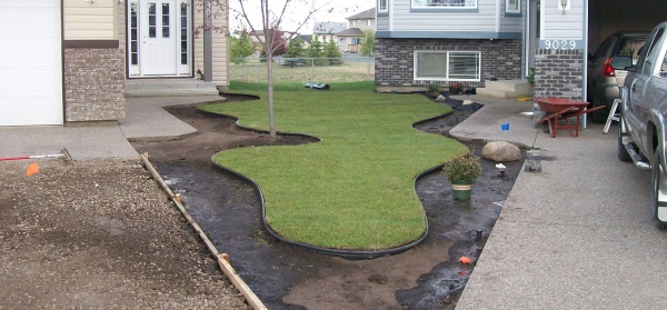 Plastic edging is an easy and affordable way to separate grass from decorative rock beds.