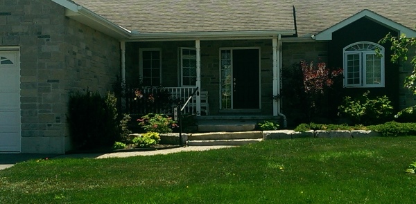 A simple front yard design using large blocks makes a nice single tier garden bed.