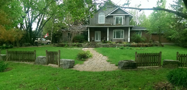 This is a unique ideas for a front yard with large rocks between smaller sections of fencing.